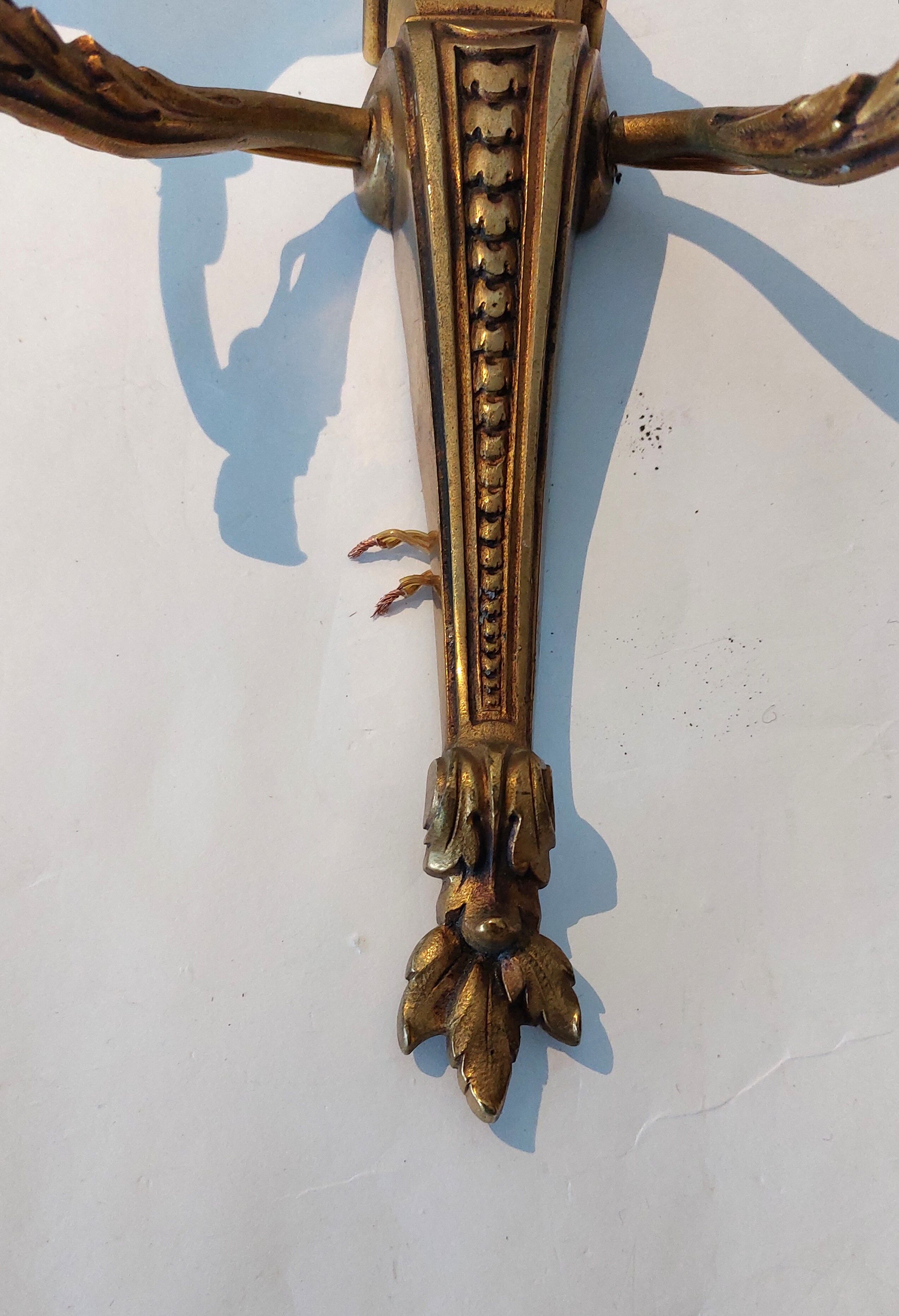 Pair of neoclassical sconces in bronze and gilded brass 1950.
