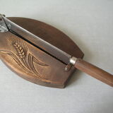 Old wooden bread cutter carved sheaf of wheat and metal deco kitchen Normandy countryside