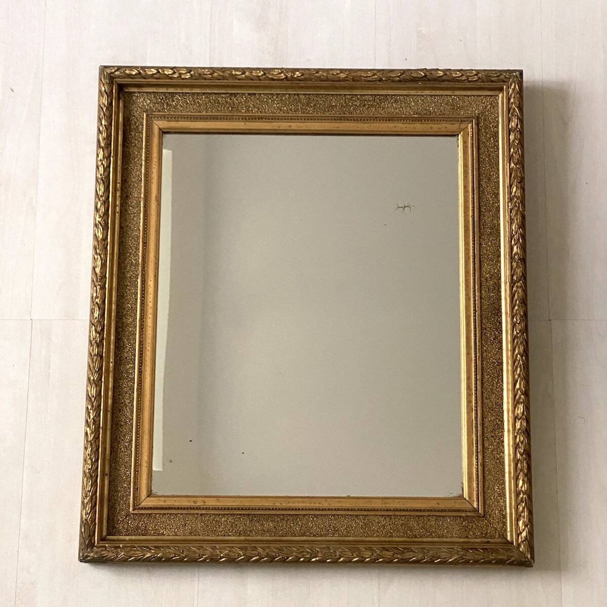 Small wooden mirror with gilded stucco in the Louis XVI style.
