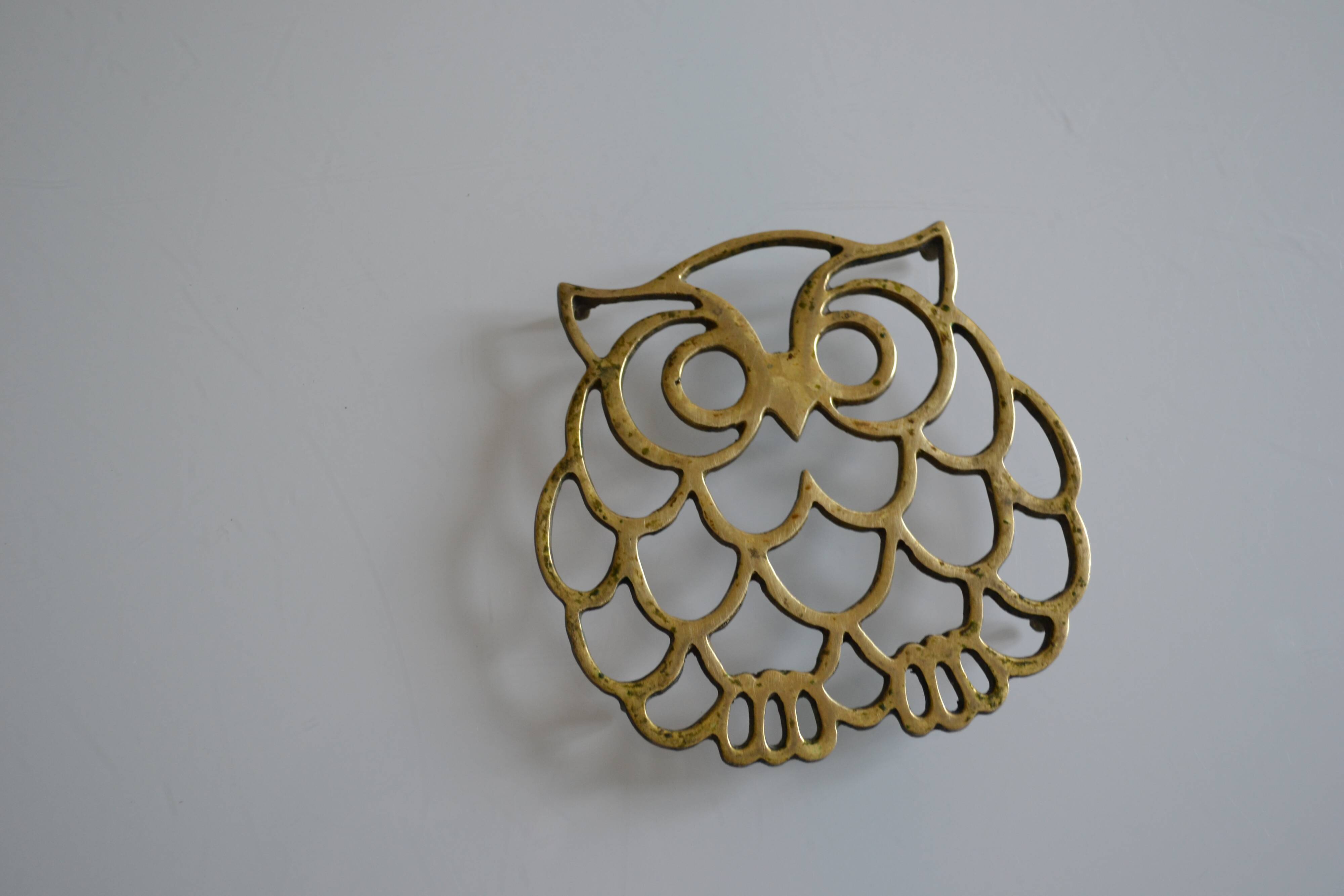 Vintage openwork brass trivet in the shape of an owl or owl