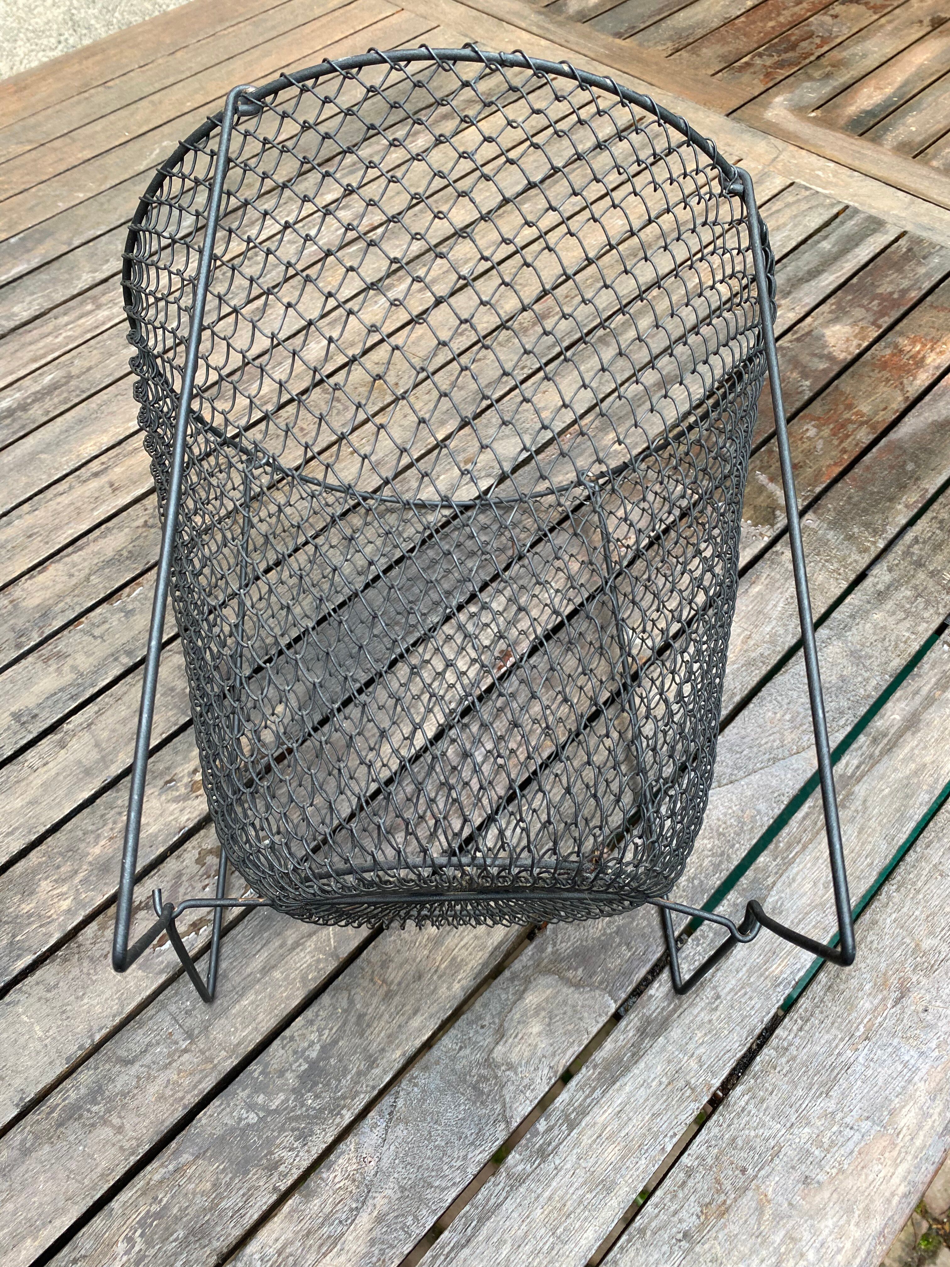 Foldable black woven metal wastepaper basket from around 1950.