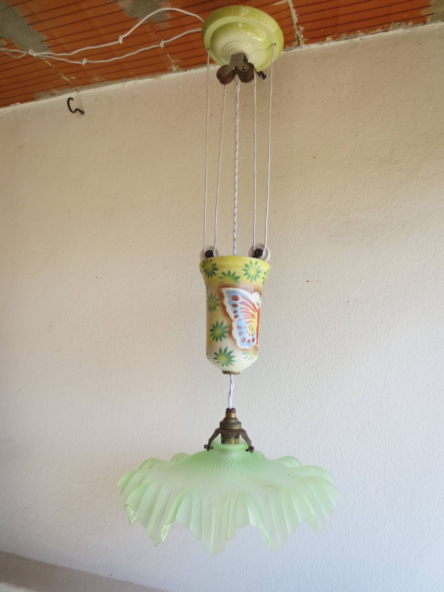 "Very old light fixture" with a "rise and fall" counterweight adorned with butterflies.