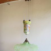 "Very old light fixture" with a "rise and fall" counterweight adorned with butterflies.