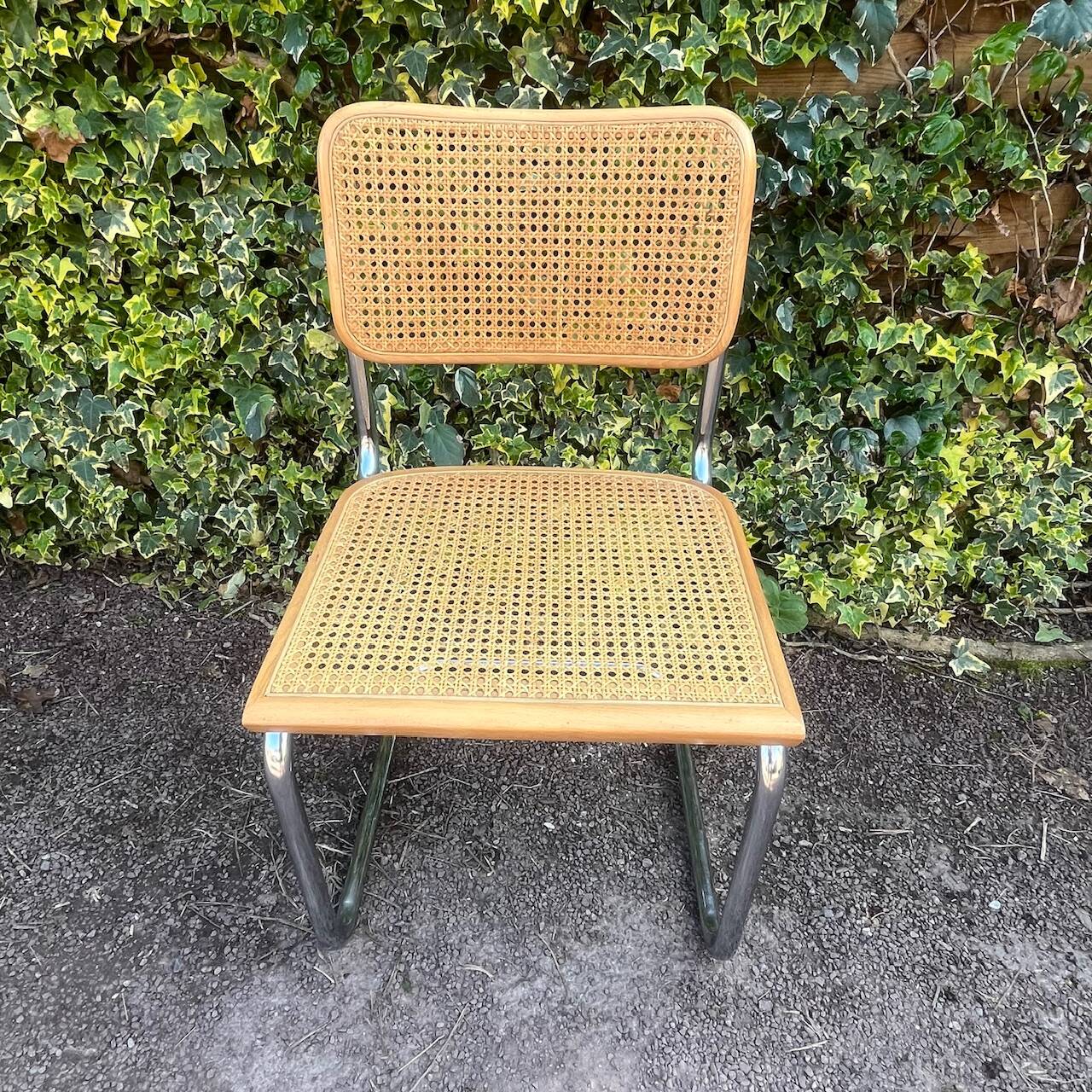 Wooden chair with caning in the style of Marcel Breuer.