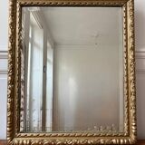 Bevelled mirror in carved gilded wood