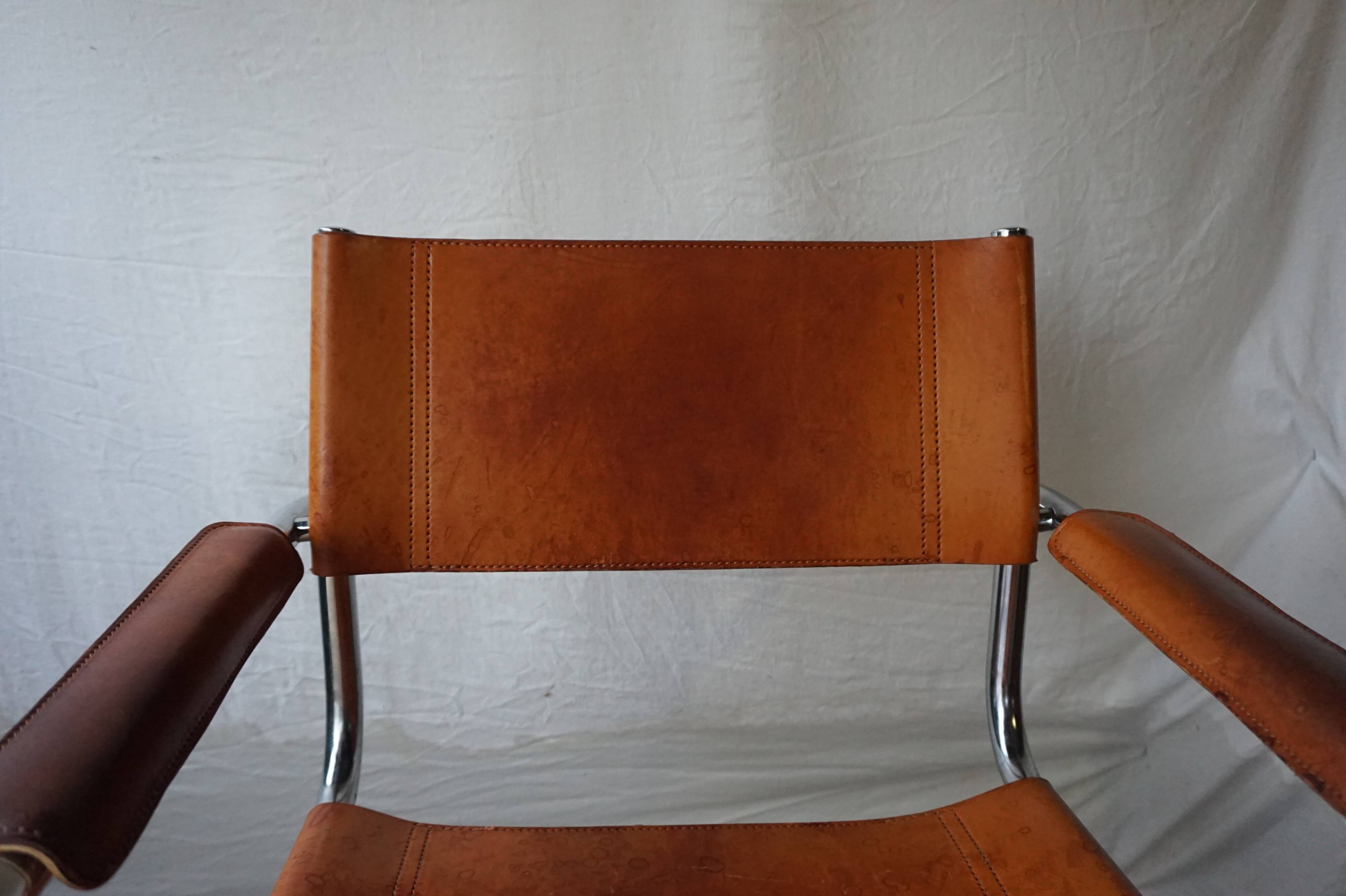 Three  leather armchairs