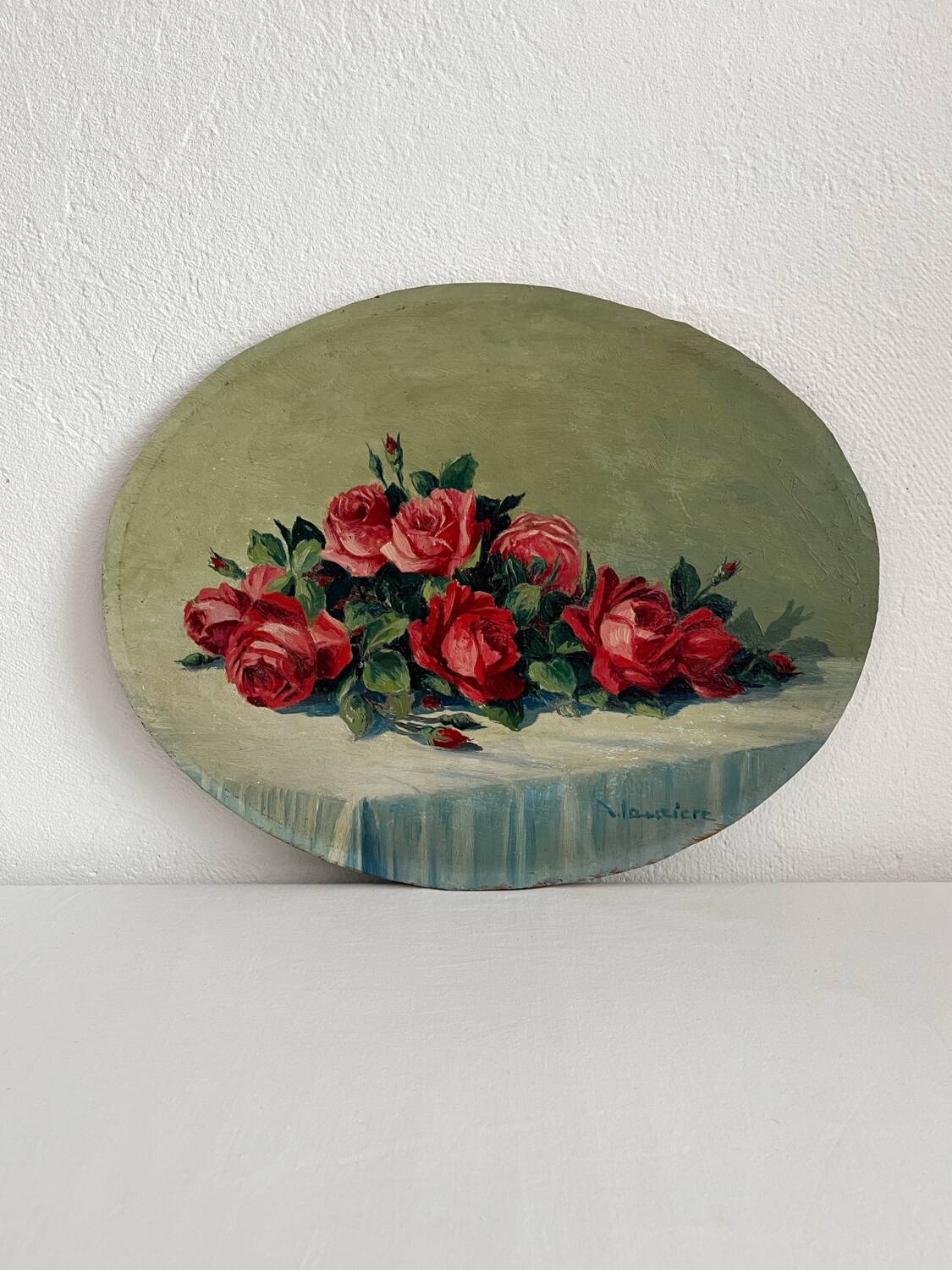 Old oil painting on oval wood with roses thrown from the 30s