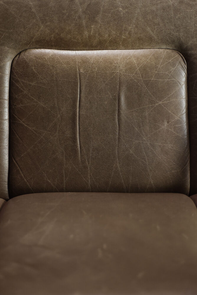 High teak and brown leather armchair with reclining backrest, mid-century Danish style, 1960s.