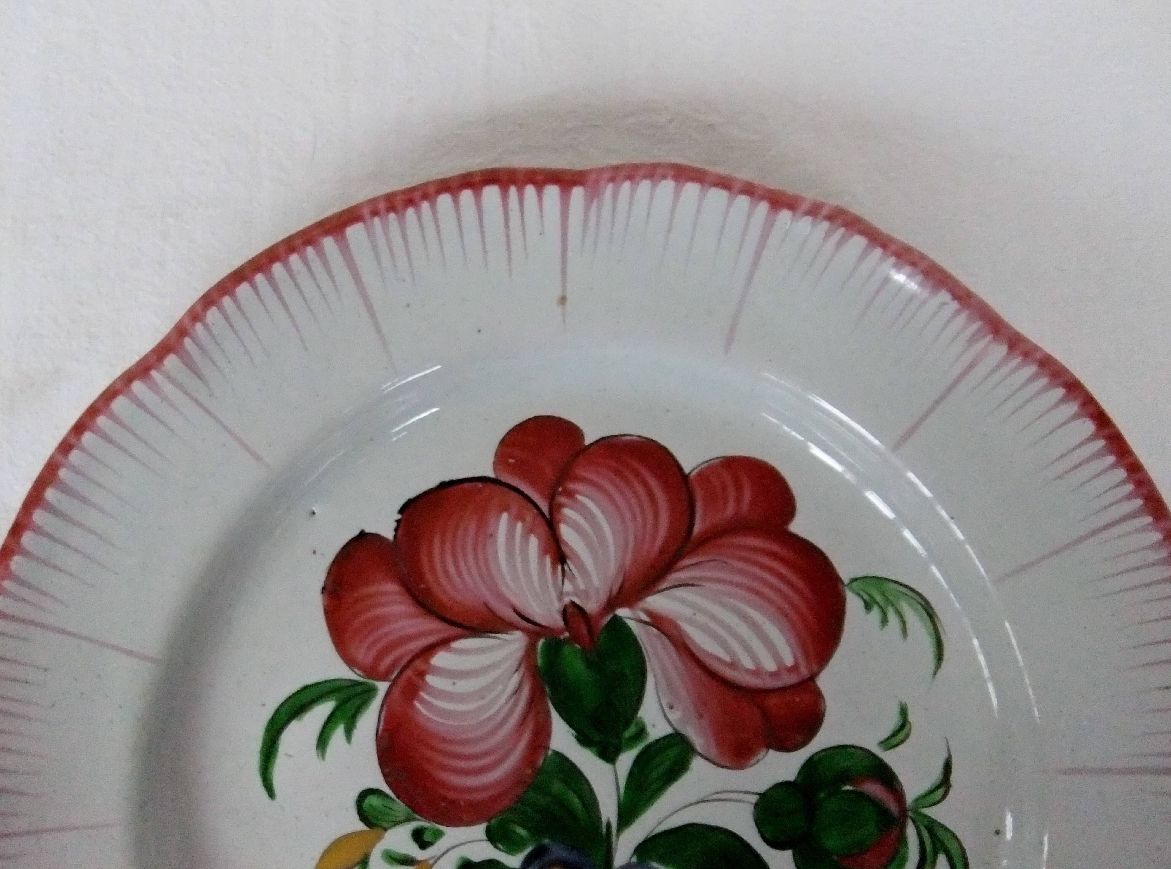 Old earthenware plate of the East Strasbourg decorated with flowers