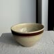 Large speckled beige salad bowl with ochre trim H14 D25