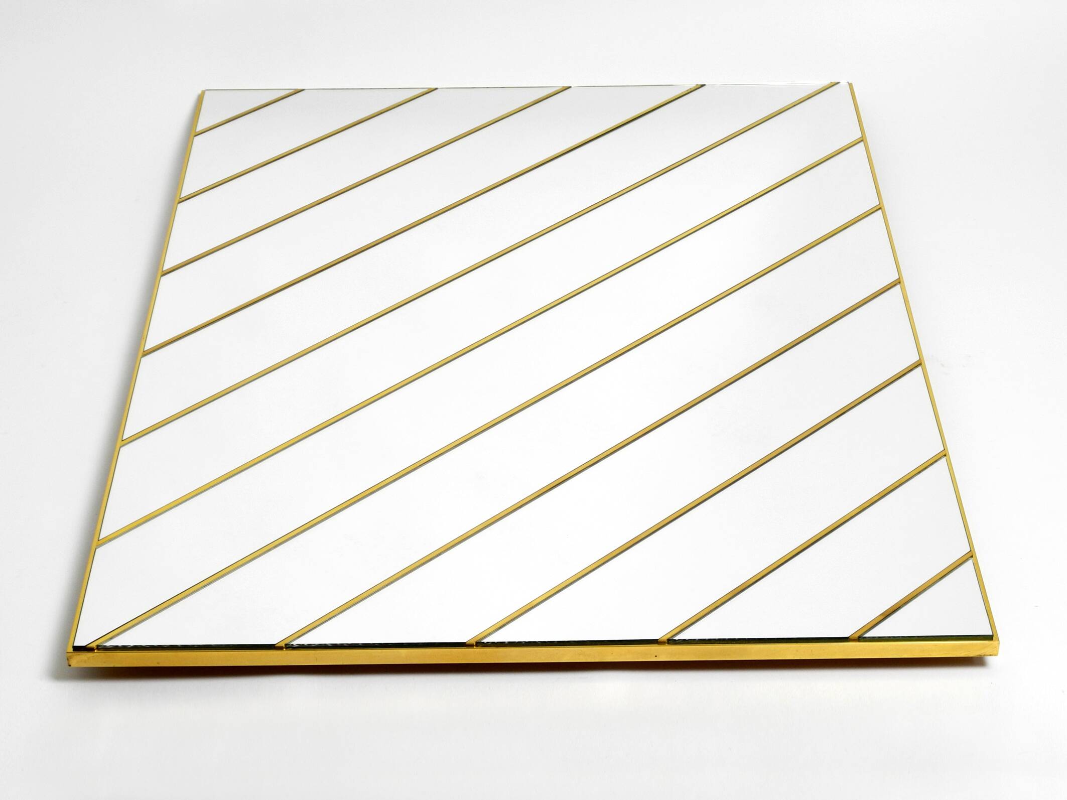 Large, exceptional 1970s brass wall mirror with diagonal mirror strips