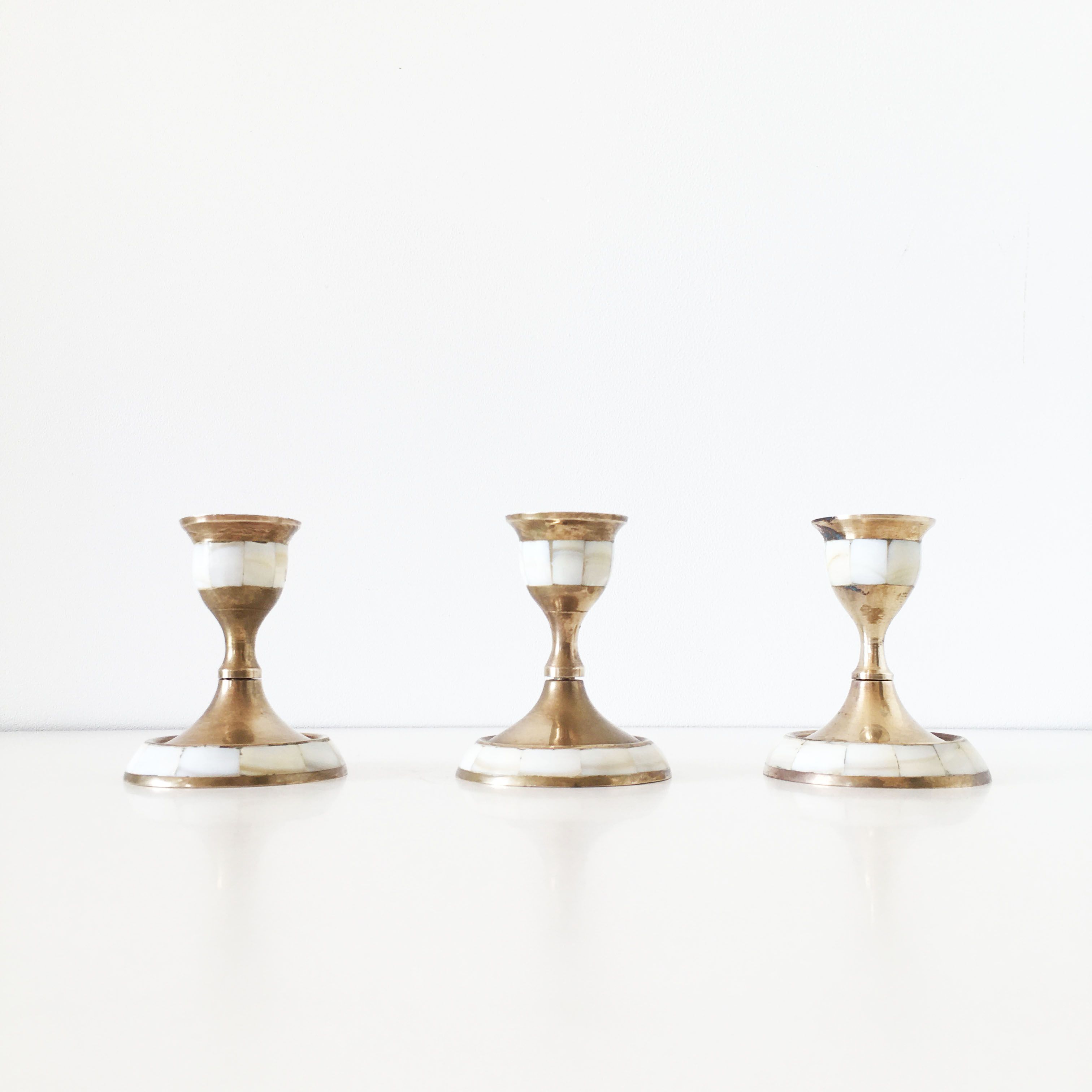 Lot of old candlesticks in brass and mother-of-pearl