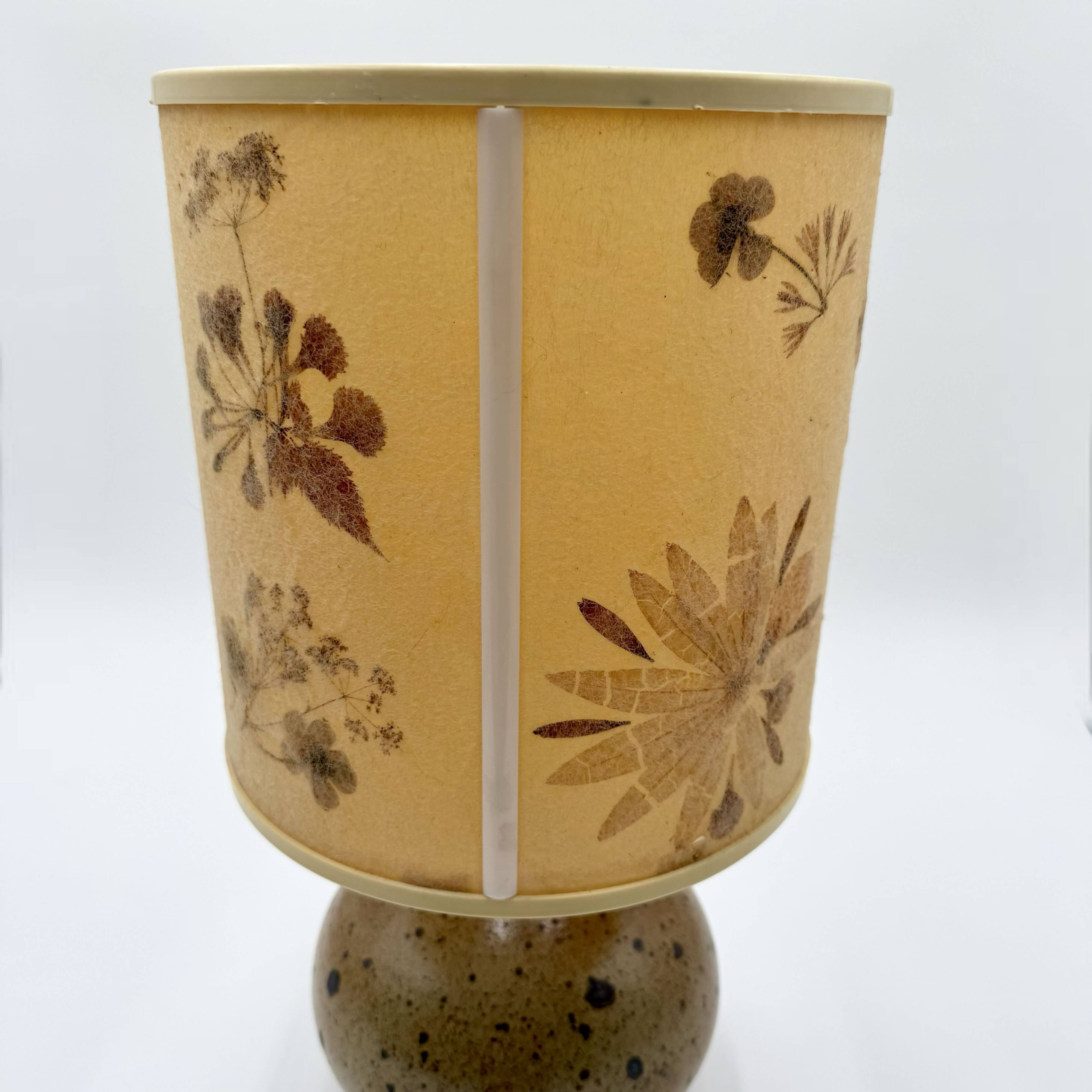 Pyrite stone ball lamp with a lampshade featuring dried flower inclusions.