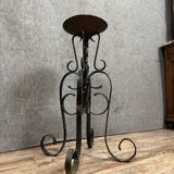 Wrought iron candlestick on four-legged base circa 1900-1930