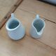 2 small white porcelain pitchers