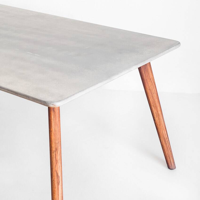 Scandinavian style dining table. Polished and varnished wood and concrete. For indoor or outdoor use.