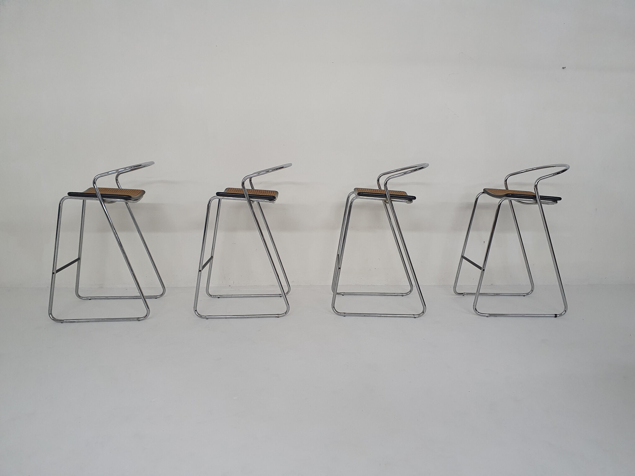 Set of four chrome and cane bar stools, 1970's