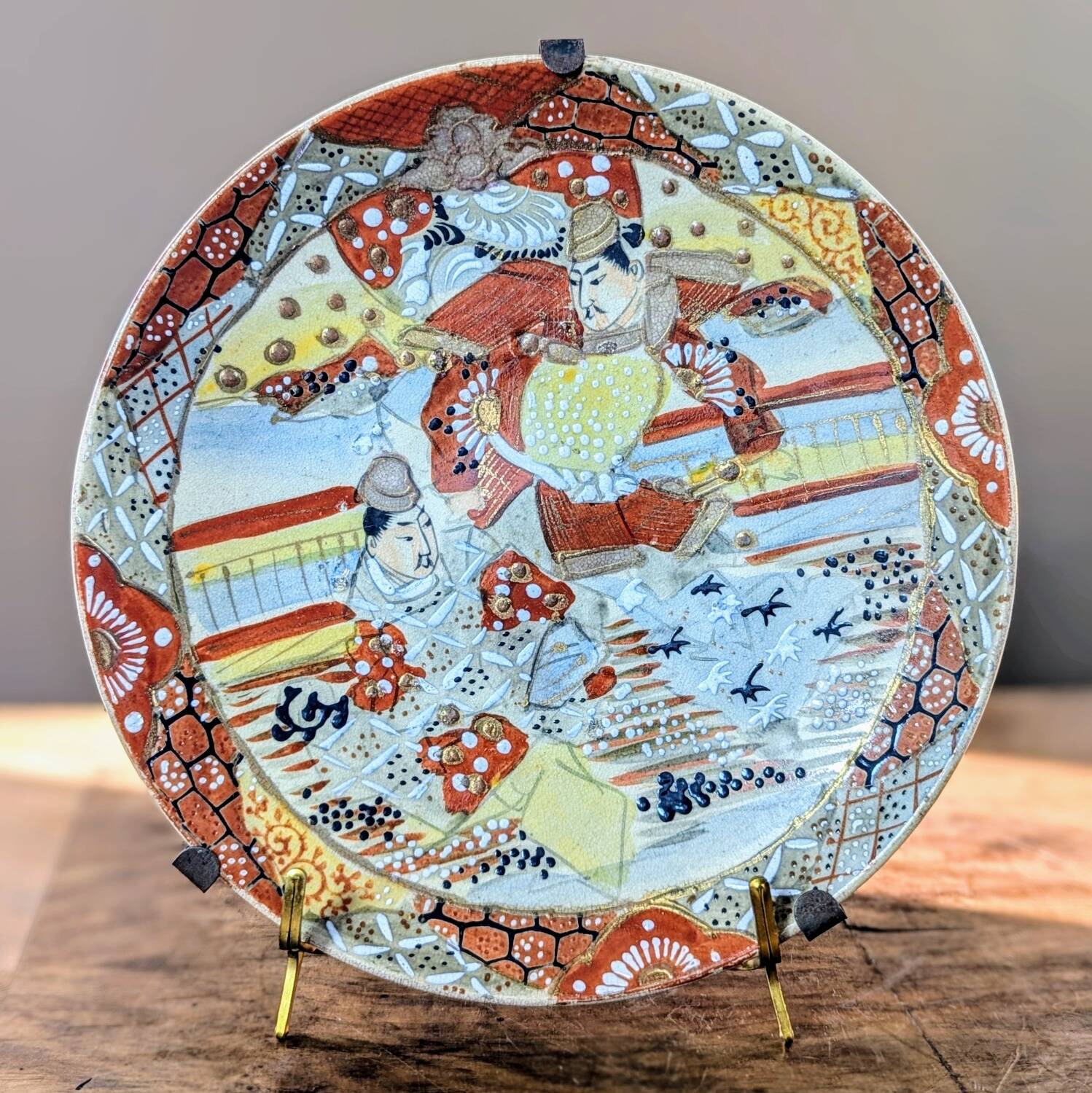 Antique Japanese Satsuma plate with red and gold decoration and figures