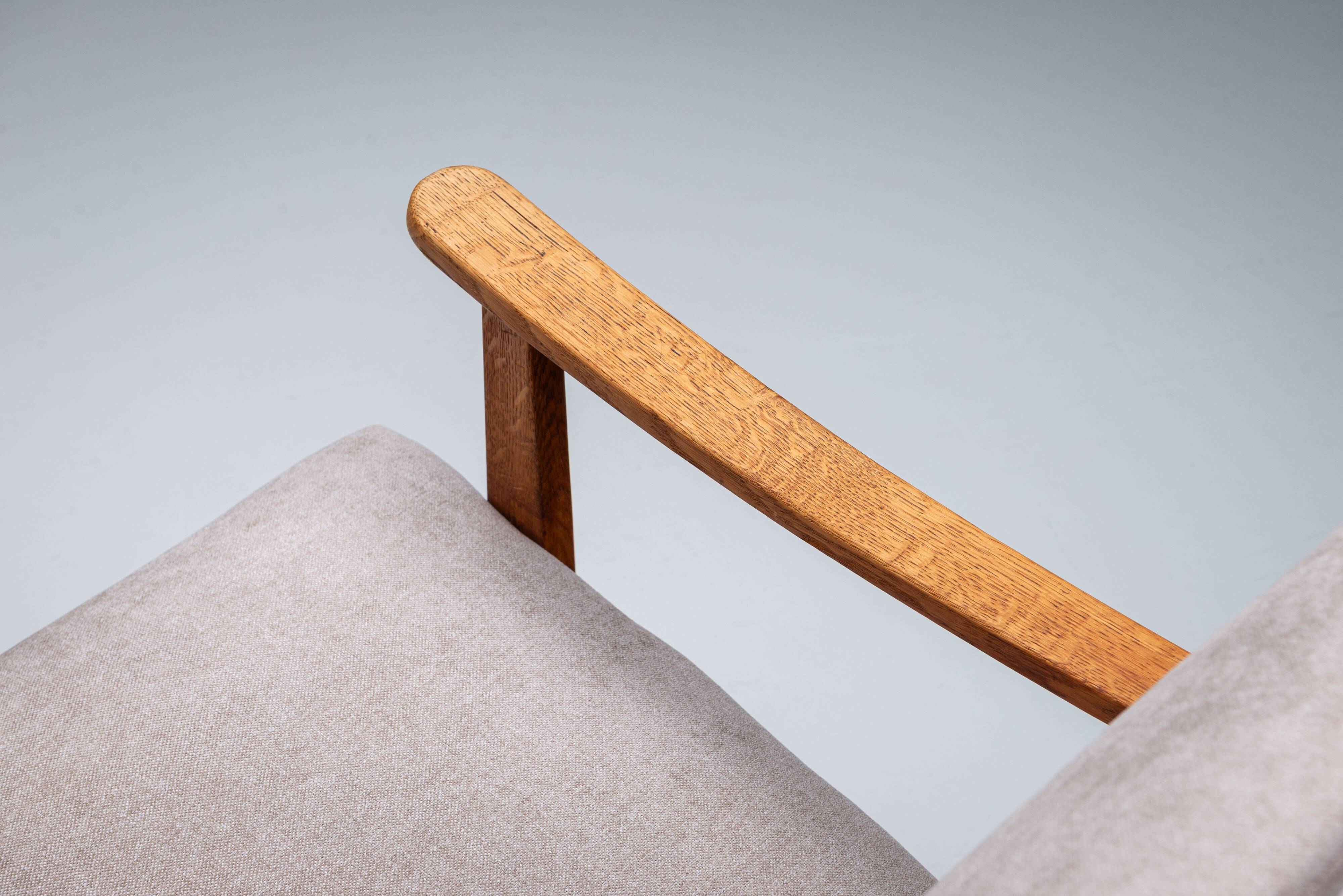 Oak armchair with curved armrests