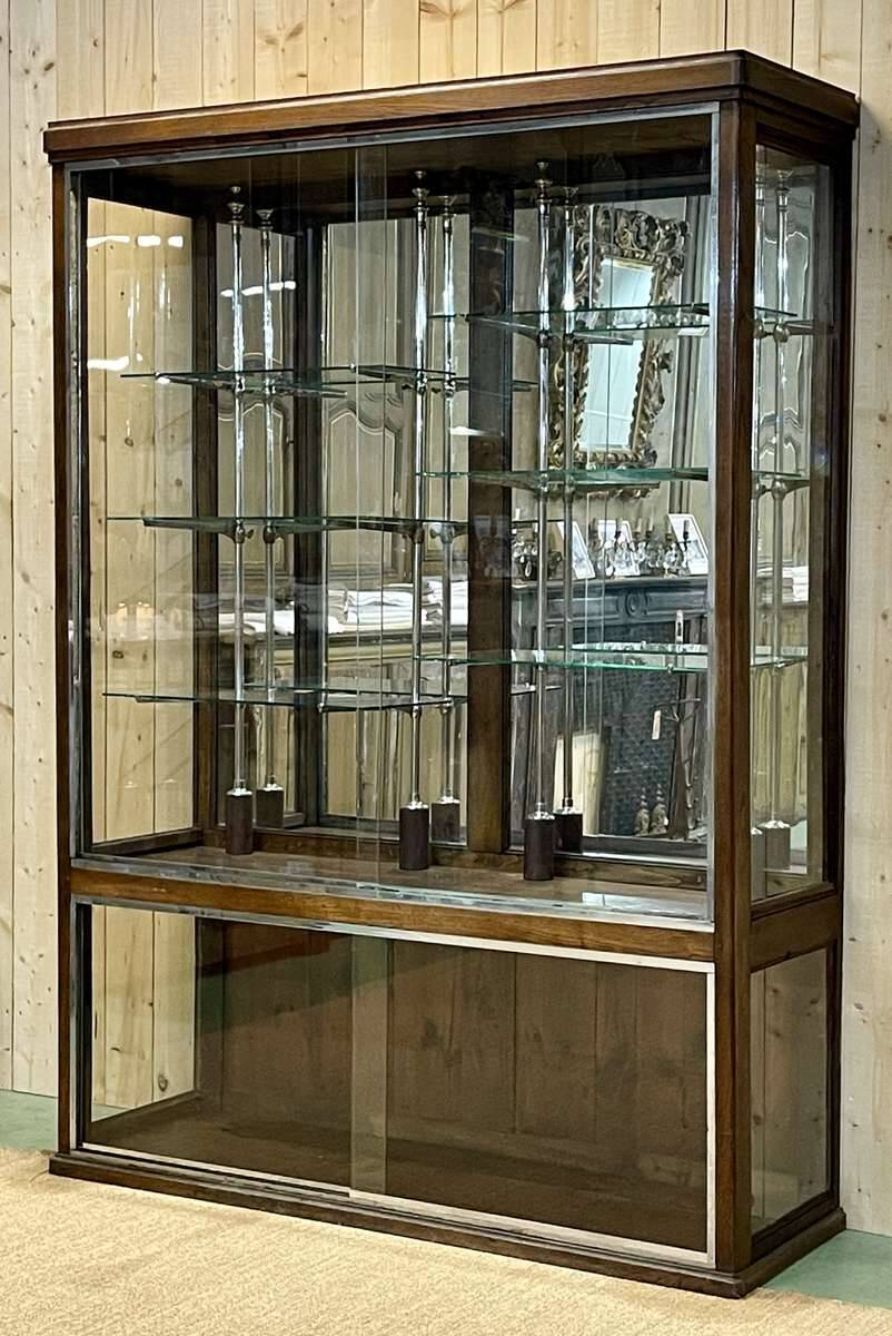 Early 20th-century shop display cabinet in oak with sliding doors.
