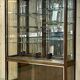 Early 20th-century shop display cabinet in oak with sliding doors.