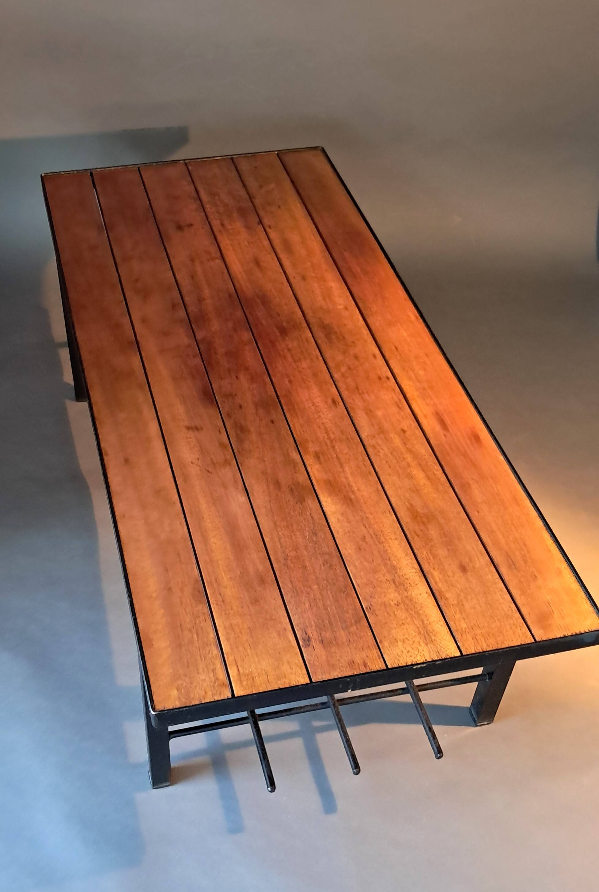 Vintage modernist coffee table in teak and black metal.