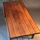 Table basse moderniste vintage en teck et métal noir.