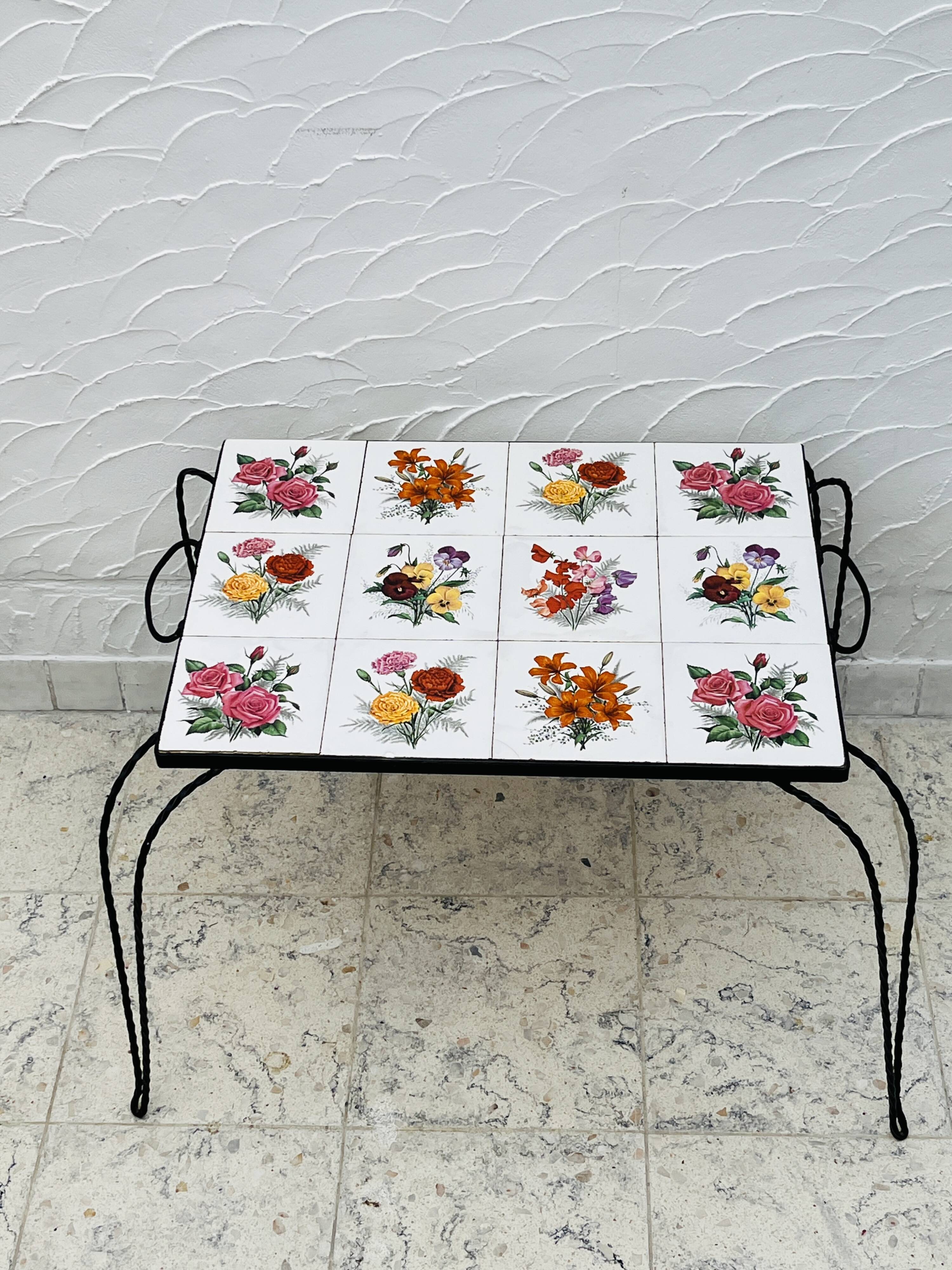 Vintage coffee table in wrought iron with floral tiles.