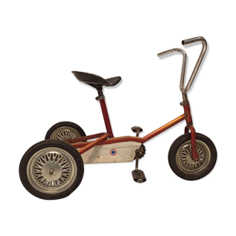 Child tricycle of the 1960s iridescent orange metal
