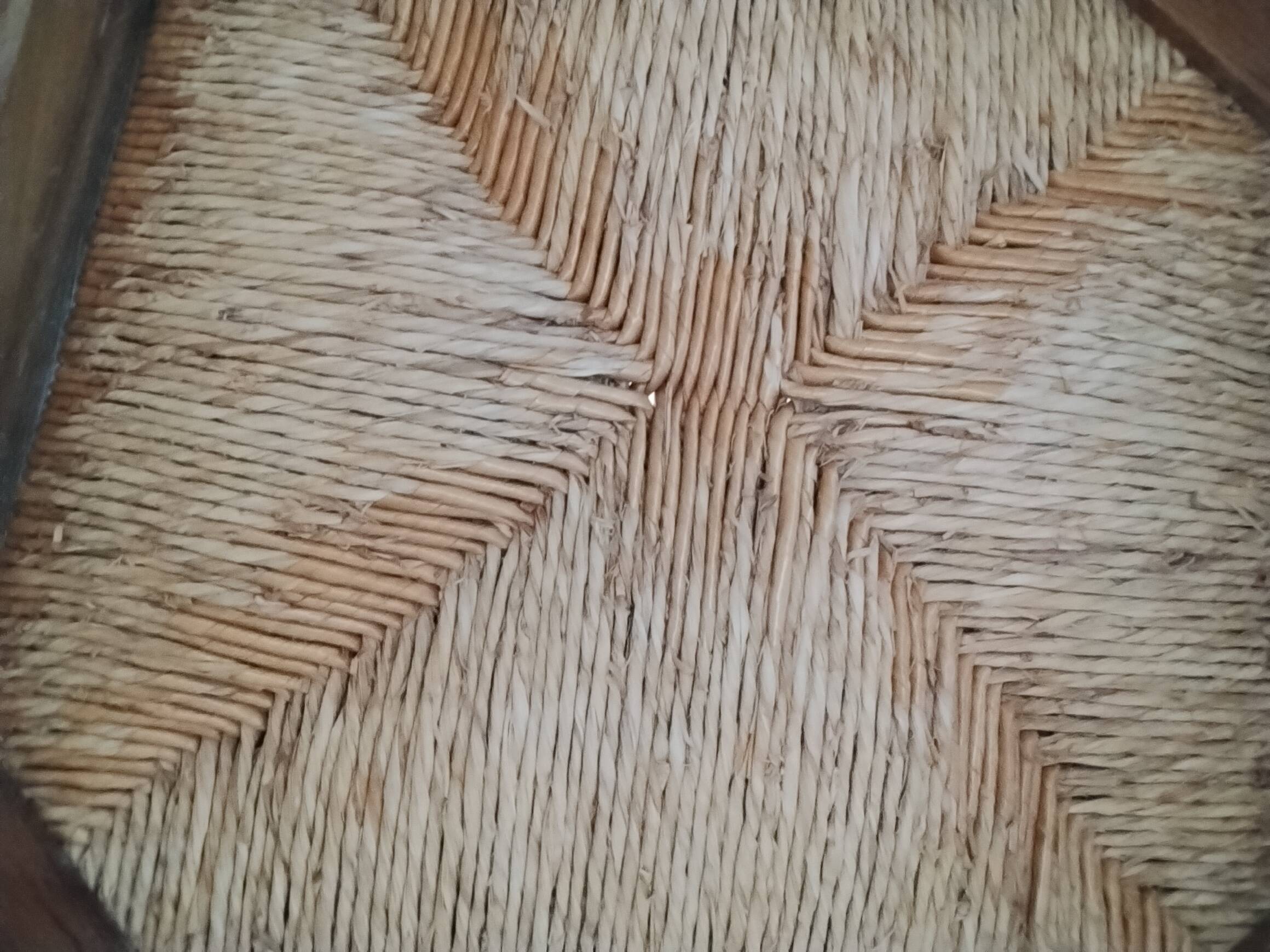 4 straw-seated solid wood chairs with high backs in rustic style.