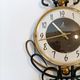 Jaz clock in black metal and golden brass, model Cabic 1967/1968