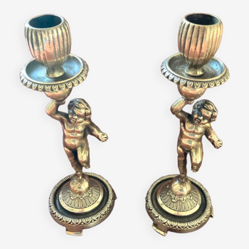 Pair of candlesticks or torches decorated with a cherub or toddler