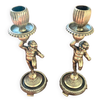 Pair of candlesticks or torches decorated with a cherub or toddler