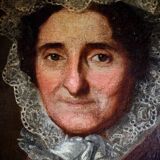 Tableau à l'huile ancien encadré d'or représentant le portrait d'une dame au chapeau