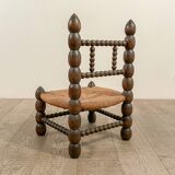 Low chair in beaded wood and straw