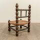 Low chair in beaded wood and straw