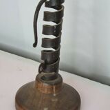 Candle holder with iron and wood pusher