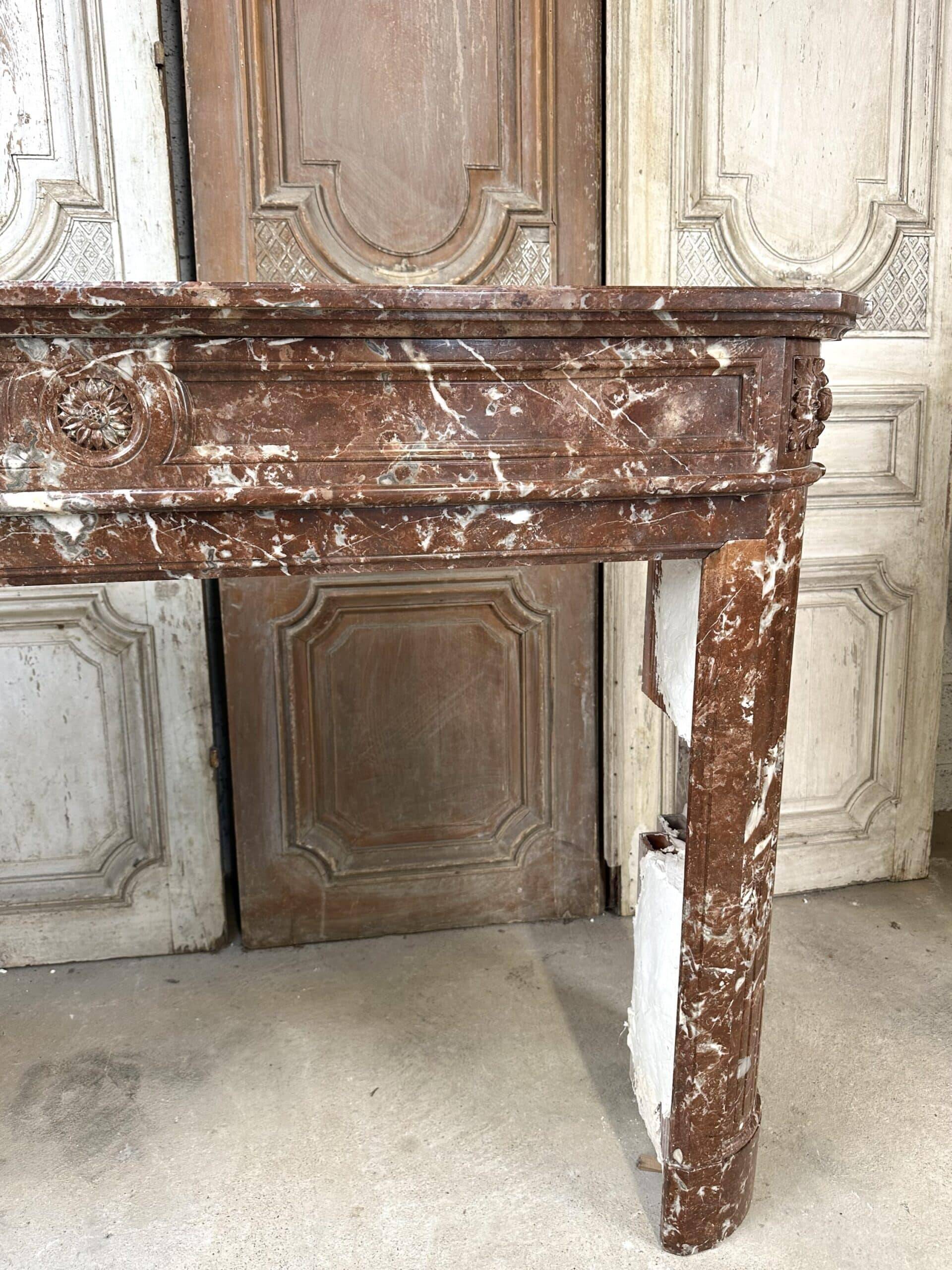 Red marble fireplace in the Louis XVI style, late 19th century