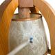 Vintage wooden wall lamp with rope detail.