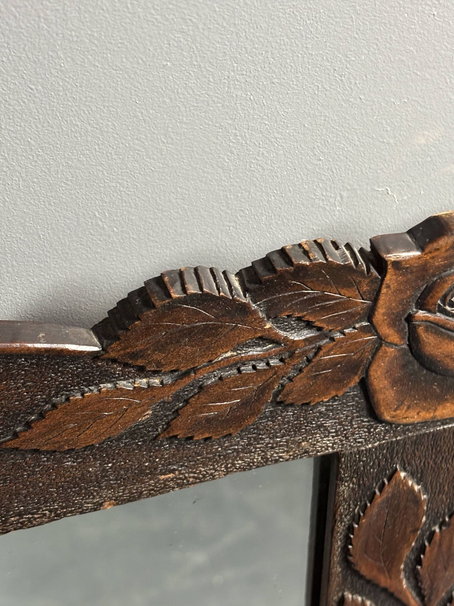 Arts & Crafts hand-carved wall mirror with floral roses, early 20th century
