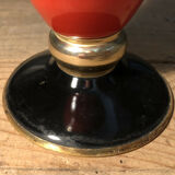 Cut vase on foot in red and black metal