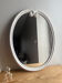 Vintage oval mirror in white enamelled cast iron