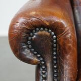Cognac-colored vintage sheep leather wingback chair with character