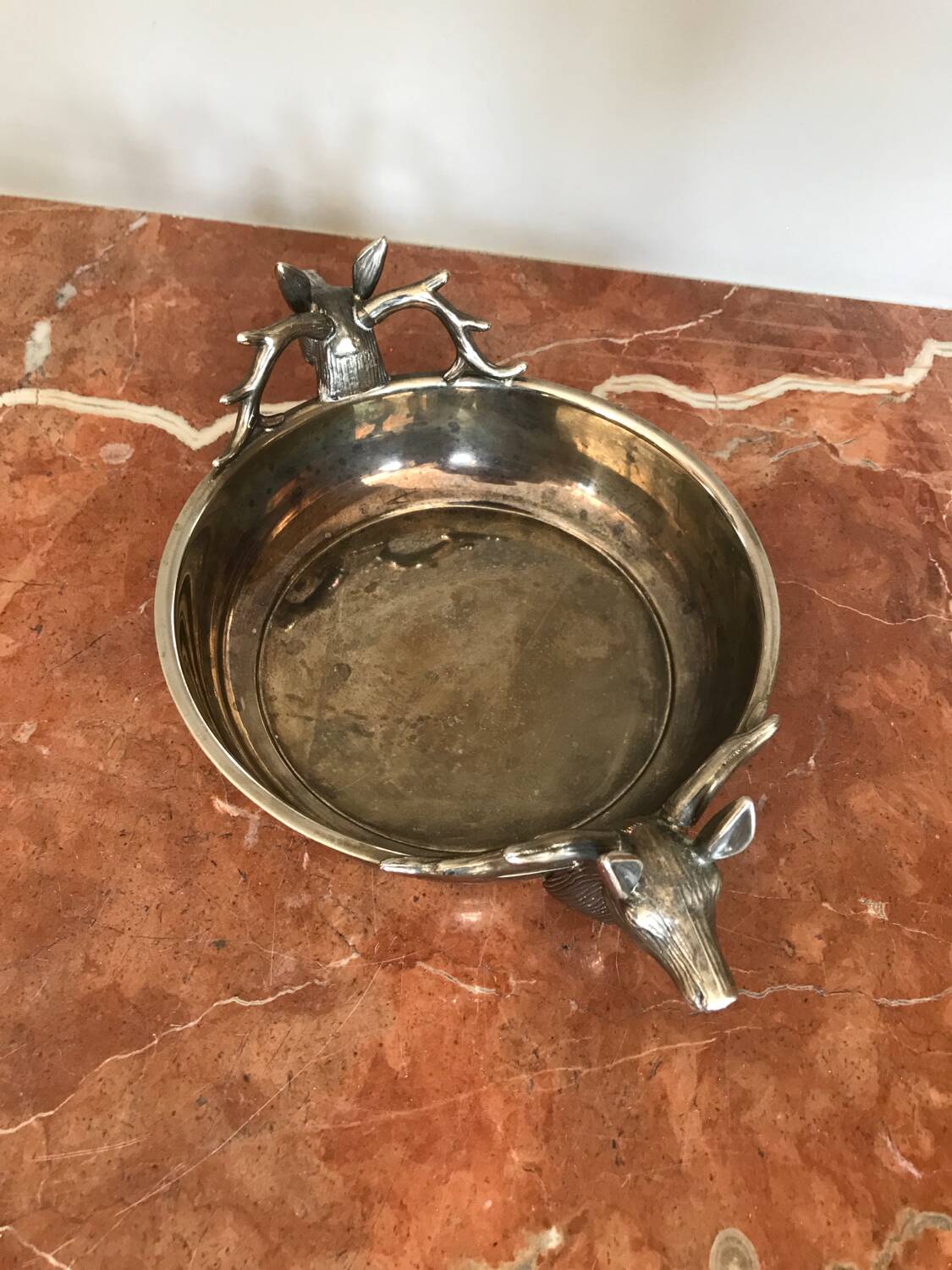 Empty silver metal pocket with deer heads