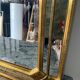 Deknudt mirror in gilded wood and with beading.