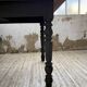 Oak farmhouse table with turned black legs.