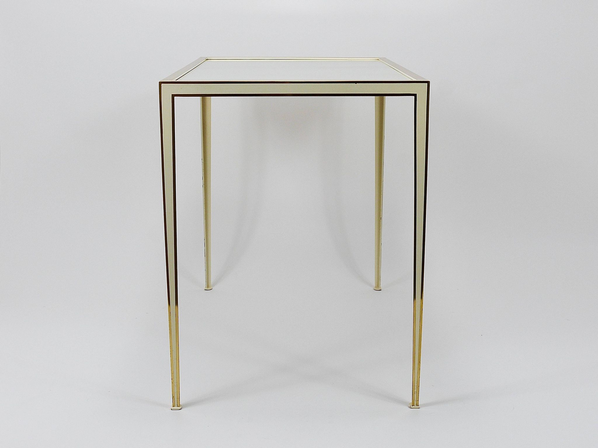 A pair of brass and white mirror tables from Vereinigte Werkstätten, Germany, 1970s.