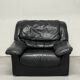 Vintage black leather lounge chair — low postmodern club chair from the space age.