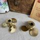 Pair of vintage brass propeller-shaped candlesticks