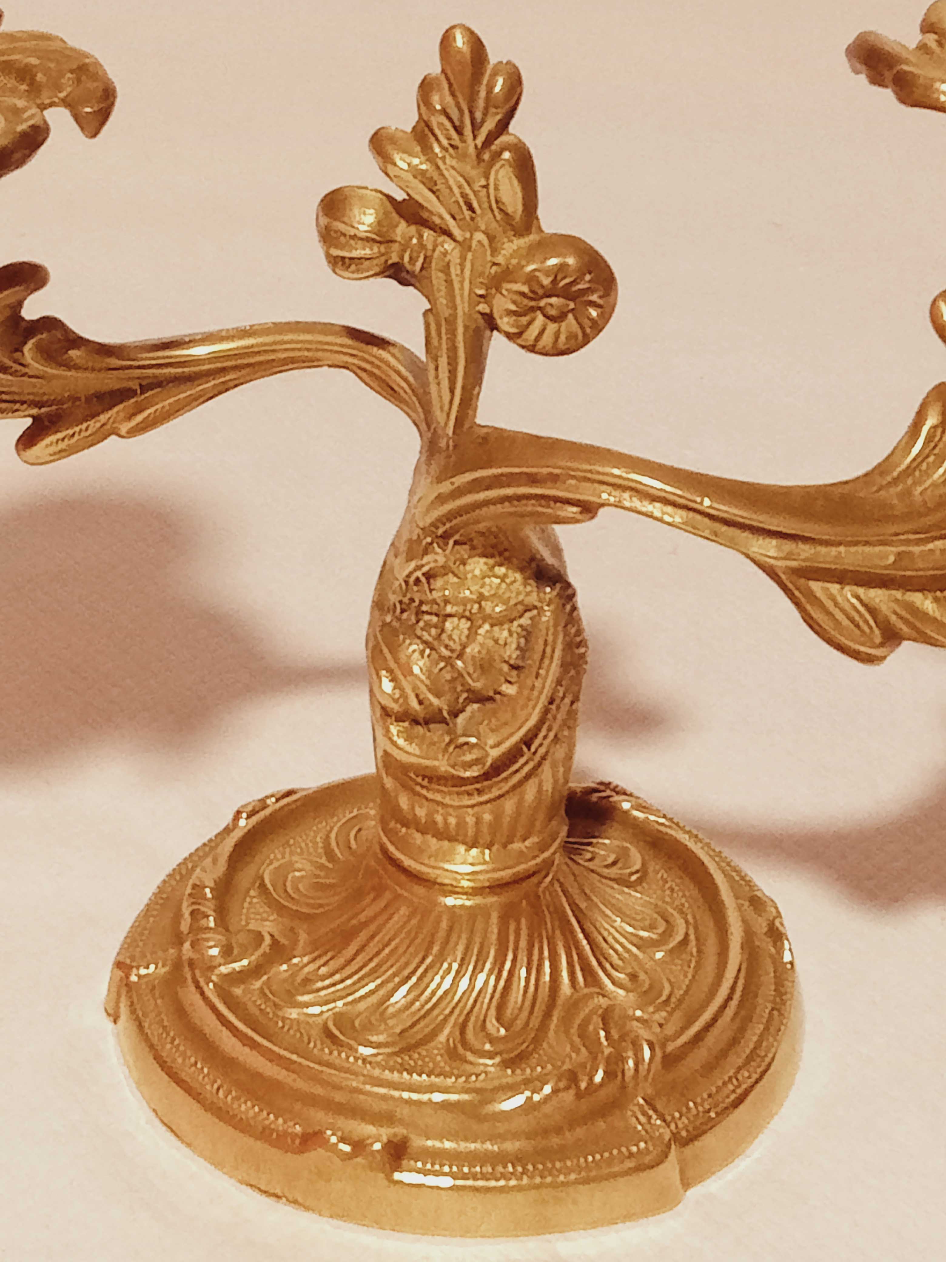 Old candle holder in gilded bronze